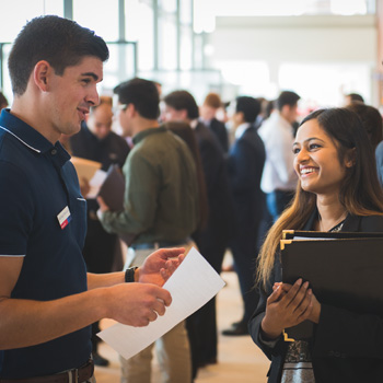 Student talking to potential employer at career fair.